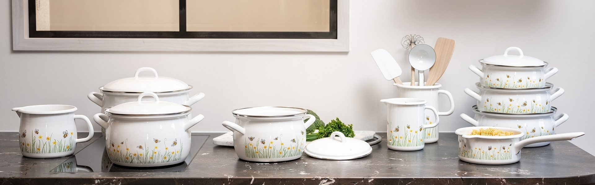 White enamel cookware set with flowers and bees